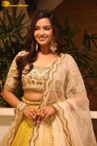 Actress Pujita Ponnada in a yellow dress while attending a movie function