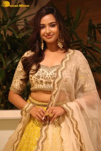 Actress Pujita Ponnada in a yellow dress while attending a movie function