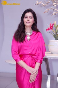 Raashi Khanna in a pink dress during a press meet