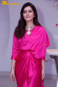 Raashi Khanna in a pink dress during a press meet