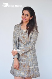 Rakul Preet Singh in a grey and white skirt and coat