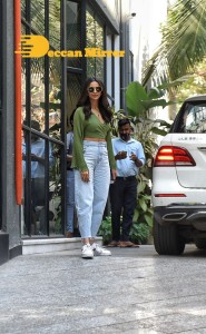 Rakul Preet Singh in a green top and blue jeans as she visits Maddock Films in Mumbai