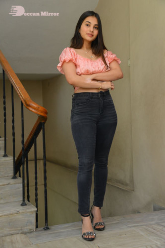 Telugu Actress Ramya Pasupuleti poses in a pink top and black jeans