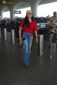 actress Rashmika Mandanna in a red top and denim jeans at airport