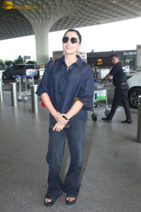 actress Rashmika Mandanna in dark denim overalls at mumbai airport