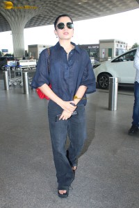 actress Rashmika Mandanna in dark denim overalls at mumbai airport