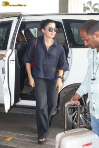actress Rashmika Mandanna in dark denim overalls at mumbai airport