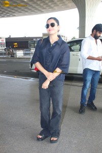 actress Rashmika Mandanna in dark denim overalls at mumbai airport