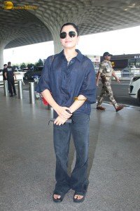 actress Rashmika Mandanna in dark denim overalls at mumbai airport