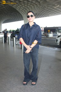 actress Rashmika Mandanna in dark denim overalls at mumbai airport