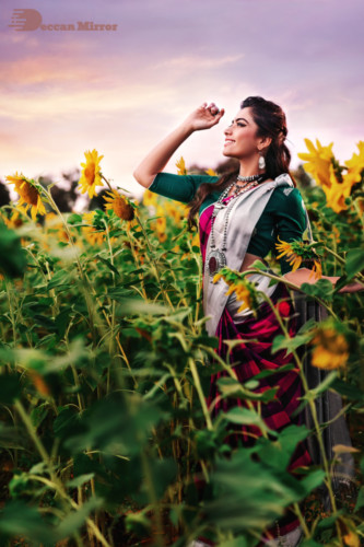 Kannada and Telugu Actress Rashmika Mandanna posing amongst flowers