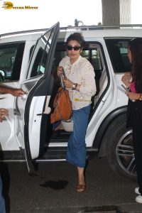 bollywood star Raveena Tandon in a white shirt and denim jeans at mumbai airport
