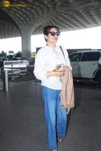bollywood star Raveena Tandon in a white shirt and denim jeans at mumbai airport