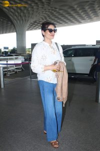 bollywood star Raveena Tandon in a white shirt and denim jeans at mumbai airport