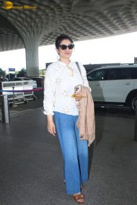 bollywood star Raveena Tandon in a white shirt and denim jeans at mumbai airport