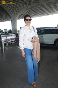 bollywood star Raveena Tandon in a white shirt and denim jeans at mumbai airport