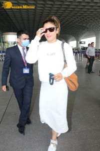 Raveena Tandon dressed in all white while traveling from Mumbai Airport