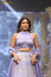 actress regina cassandra in a purple lehenga choli doing a ramp walk