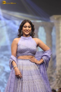 actress regina cassandra in a purple lehenga choli doing a ramp walk