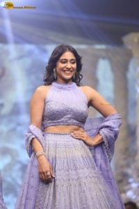 actress regina cassandra in a purple lehenga choli doing a ramp walk