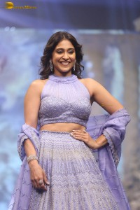actress regina cassandra in a purple lehenga choli doing a ramp walk
