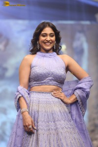actress regina cassandra in a purple lehenga choli doing a ramp walk