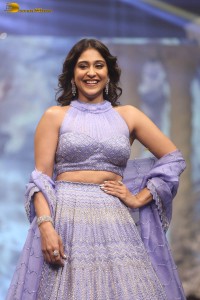 actress regina cassandra in a purple lehenga choli doing a ramp walk