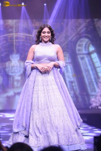 actress regina cassandra in a purple lehenga choli doing a ramp walk