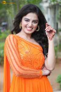 indian actress roshni sahota glamorous in a shoulderless orange dress