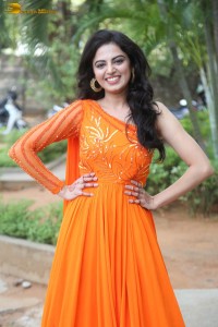 indian actress roshni sahota glamorous in a shoulderless orange dress