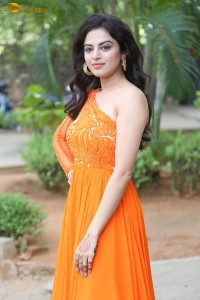 indian actress roshni sahota glamorous in a shoulderless orange dress