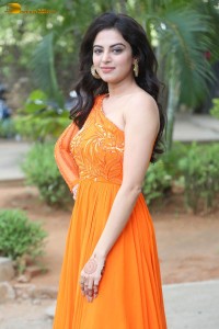 indian actress roshni sahota glamorous in a shoulderless orange dress