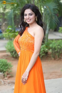 indian actress roshni sahota glamorous in a shoulderless orange dress