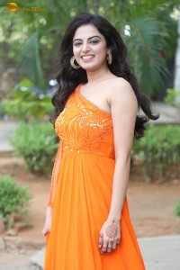 indian actress roshni sahota glamorous in a shoulderless orange dress