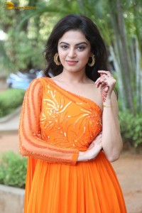 indian actress roshni sahota glamorous in a shoulderless orange dress