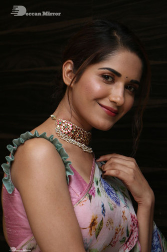 Telugu Actress Ruhani Sharma in a white and pink saree
