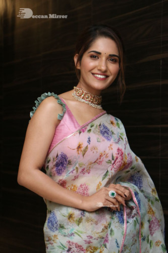 Telugu Actress Ruhani Sharma in a white and pink saree