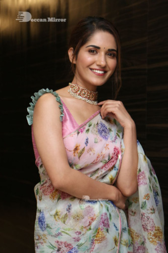 Telugu Actress Ruhani Sharma in a white and pink saree