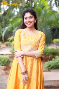 Actress Sai Pallavi in a yellow salwar kameez dress
