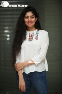 Actress Sai Pallavi in white top and blue jeans