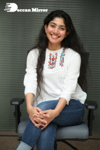 Actress Sai Pallavi in white top and blue jeans