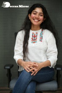 Actress Sai Pallavi in white top and blue jeans