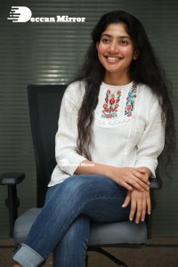 Actress Sai Pallavi in white top and blue jeans