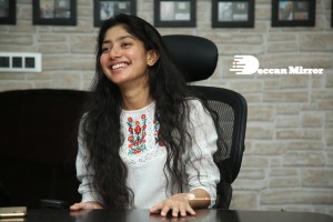 Actress Sai Pallavi in white top and blue jeans