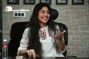 Actress Sai Pallavi in white top and blue jeans