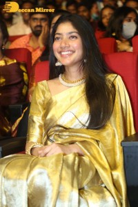 Actress Sai Pallavi in a yellow golden saree while attending a movie event
