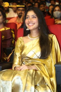 Actress Sai Pallavi in a yellow golden saree while attending a movie event