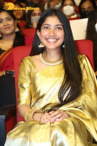 Actress Sai Pallavi in a yellow golden saree while attending a movie event
