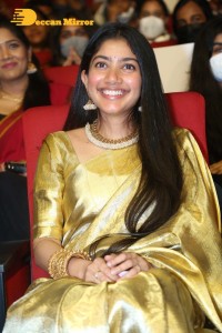 Actress Sai Pallavi in a yellow golden saree while attending a movie event