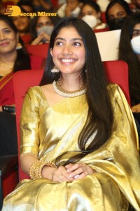 Actress Sai Pallavi in a yellow golden saree while attending a movie event